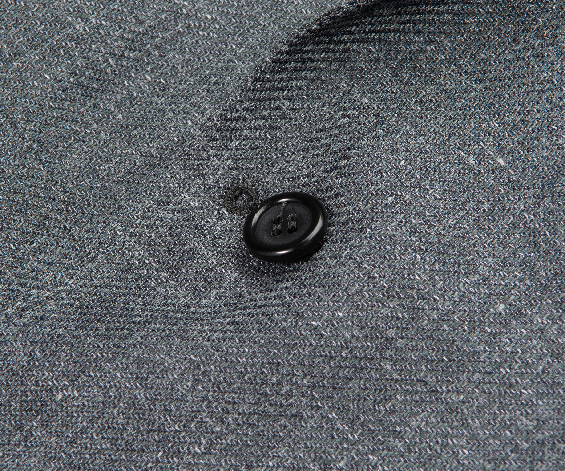 Close-up of a button on a textured gray fabric surface