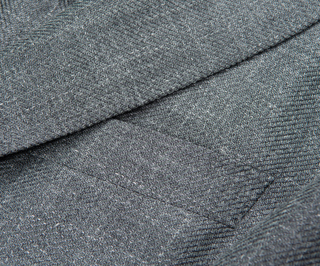 Close-up of gray textured fabric with a diagonal seam