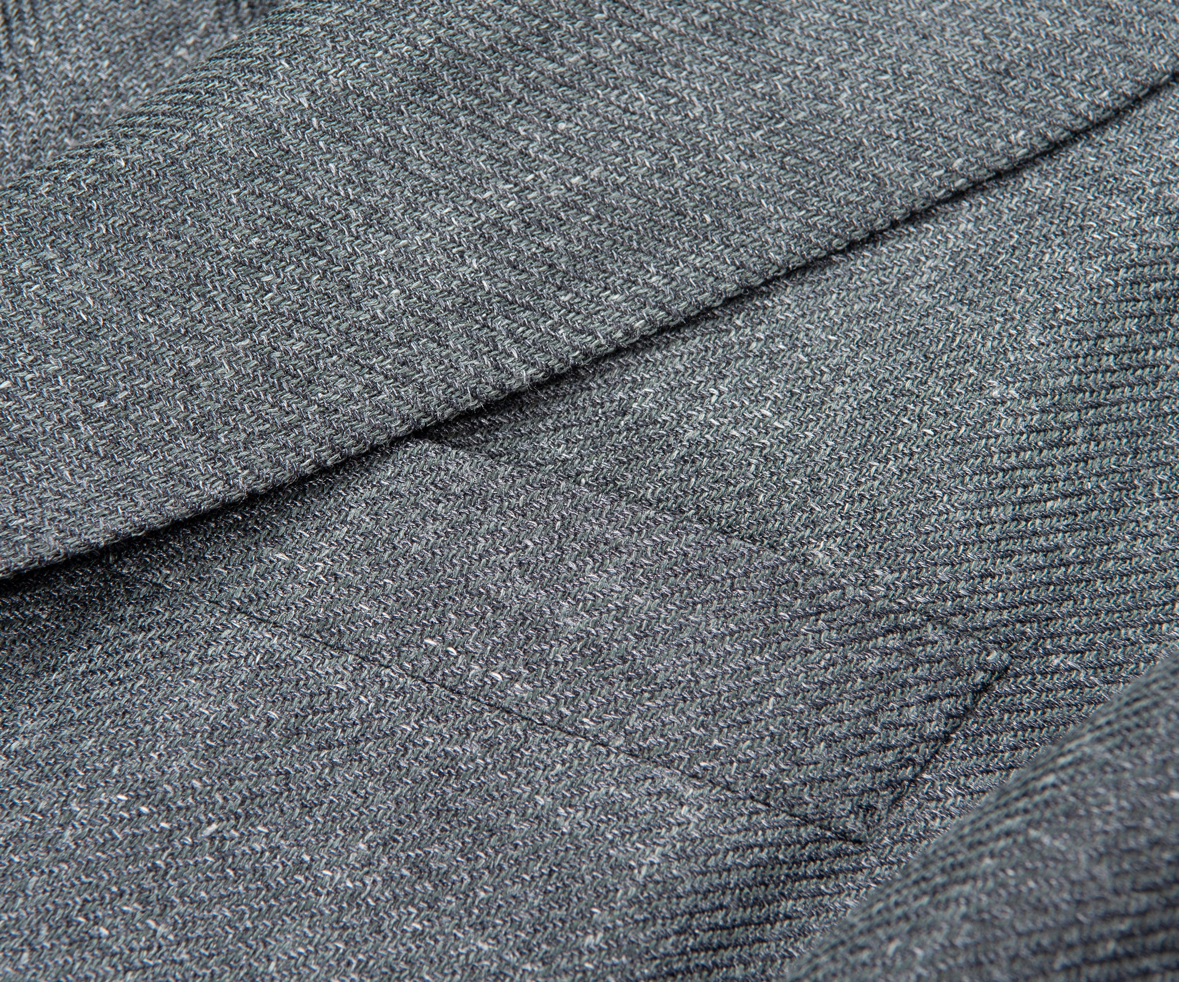 Close-up of gray textured fabric with a diagonal seam