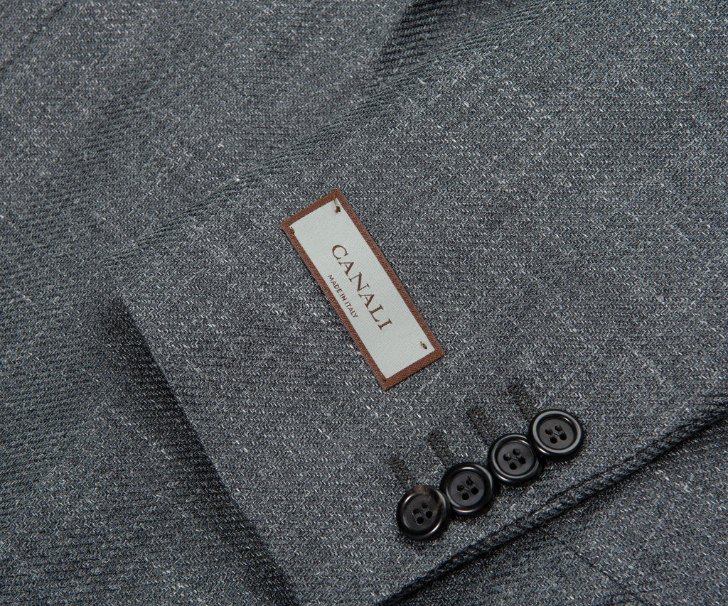 Close-up of a gray textured fabric with a Canali label and buttons.