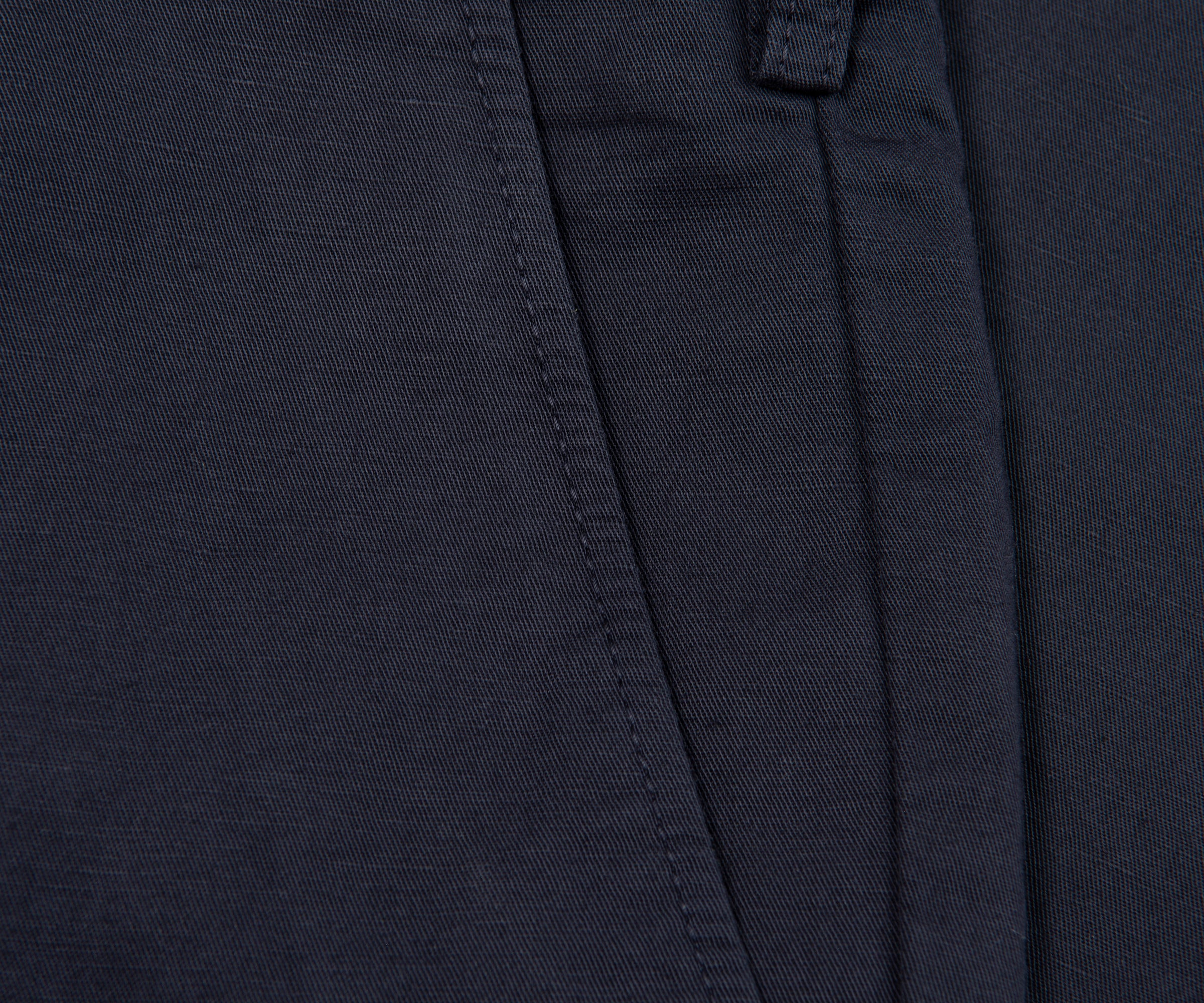 Close-up of dark blue fabric with stitching details
