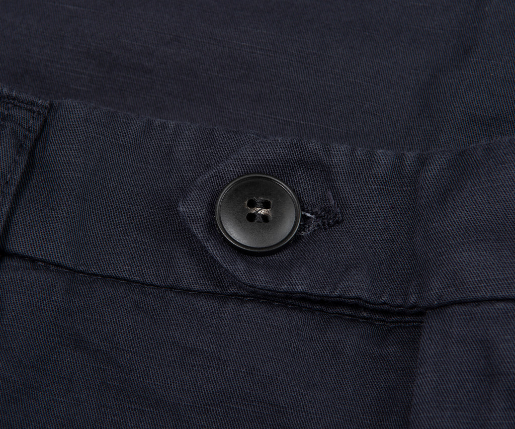 Close-up of a button on a dark fabric surface