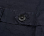 Close-up of a button on a dark fabric surface