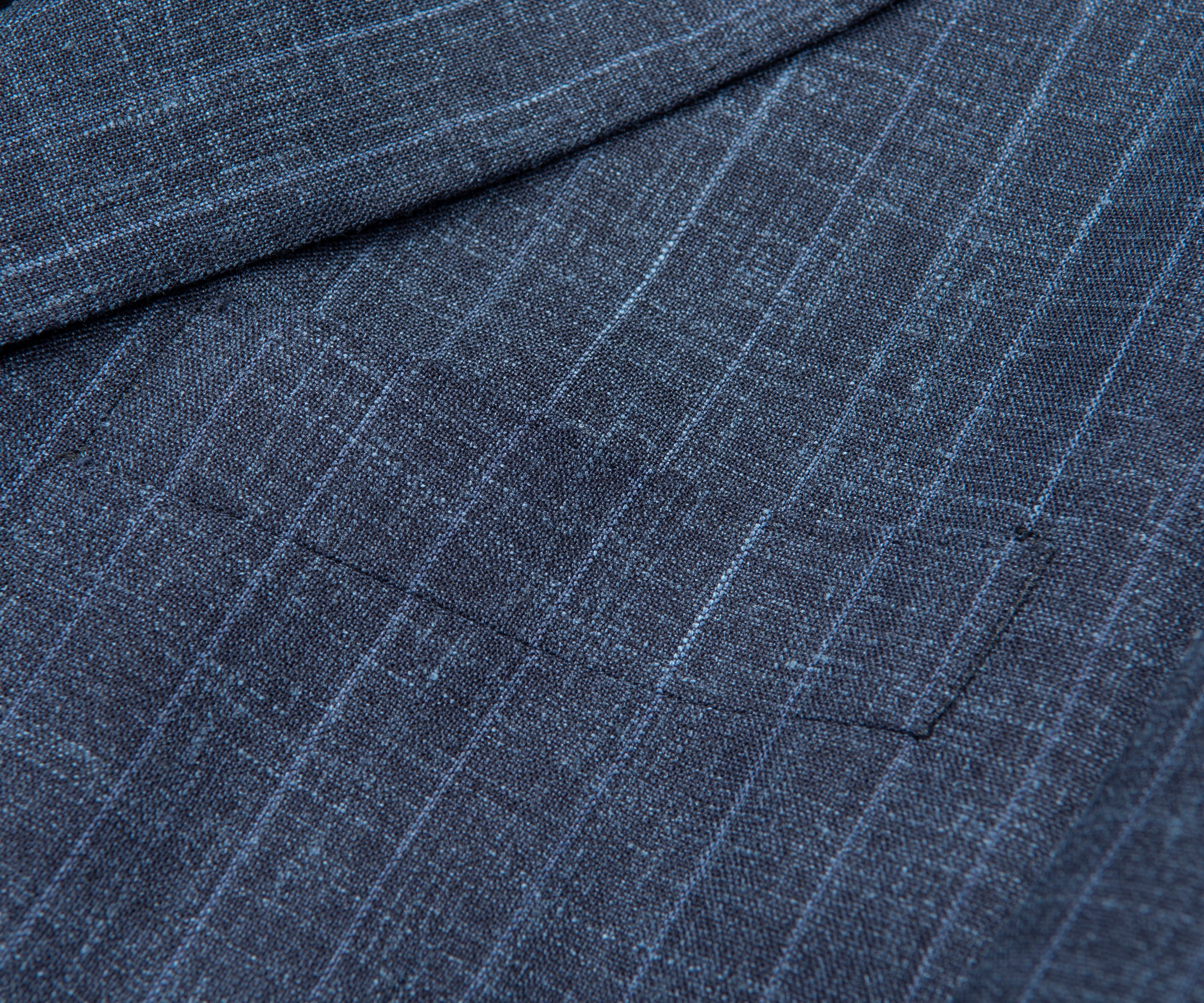 Close-up of blue pinstripe fabric with a pocket detail