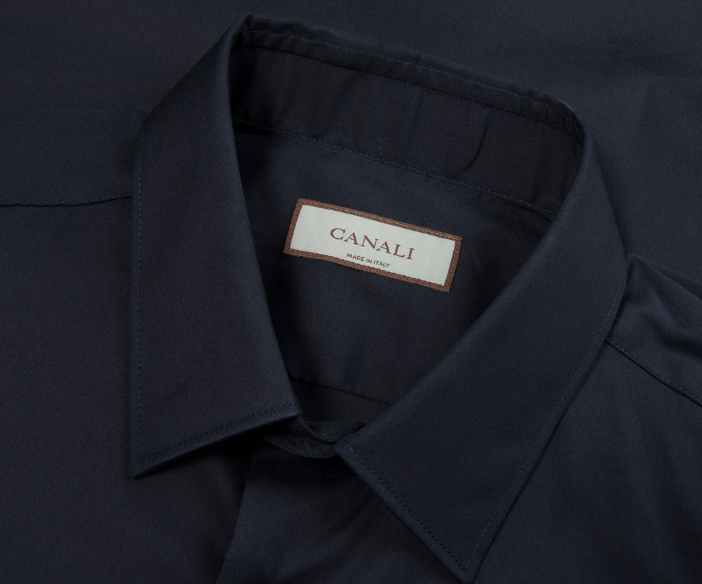 Close-up of a dark blue shirt collar with a Canali label.