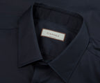 Close-up of a dark blue shirt collar with a Canali label.