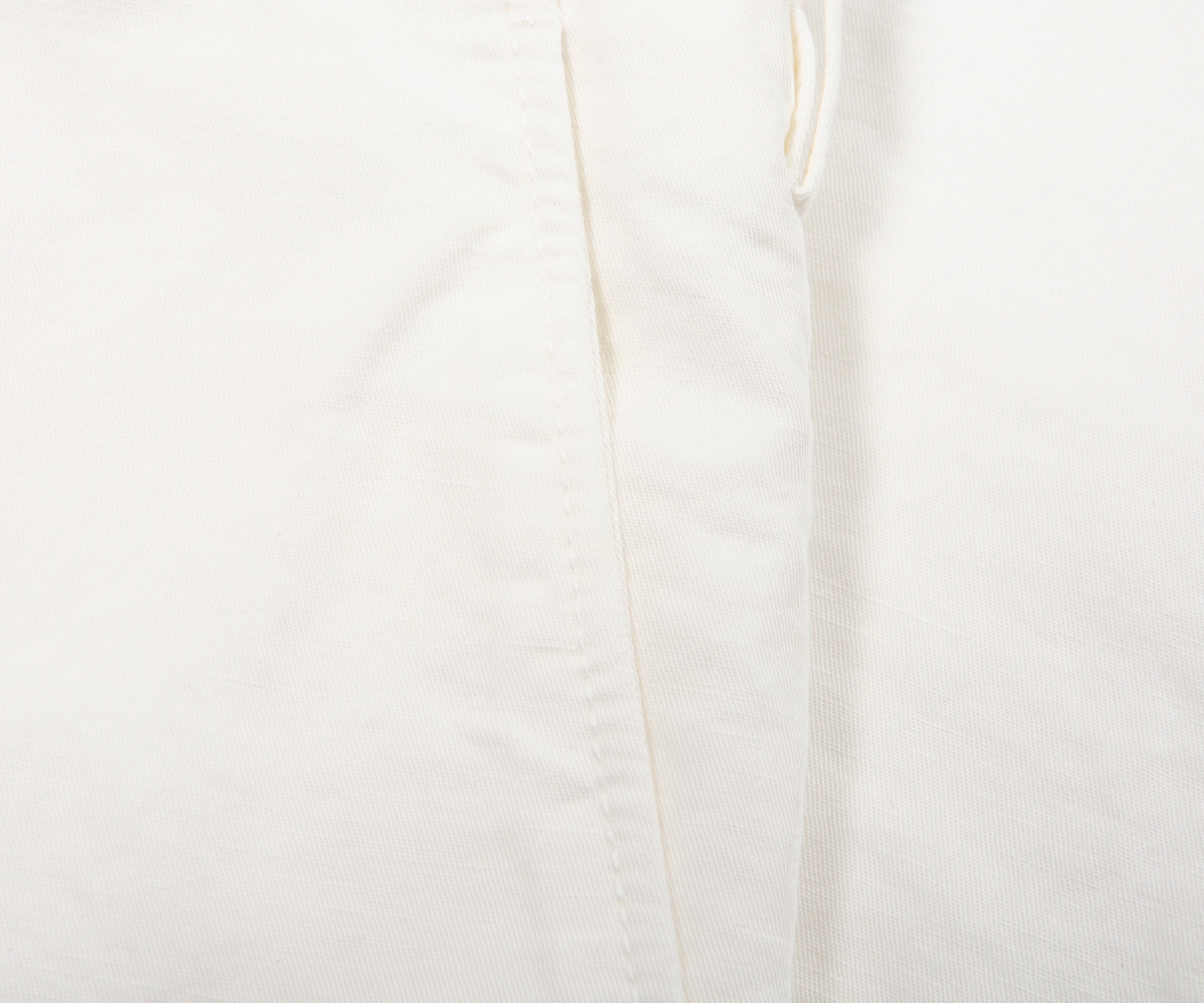 Close-up of a white fabric texture with a subtle pattern