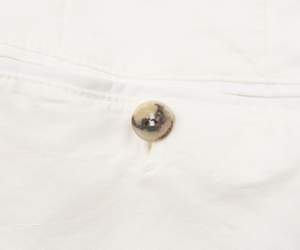 Close-up of a button on a white shirt