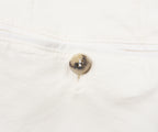 Close-up of a button on a white shirt
