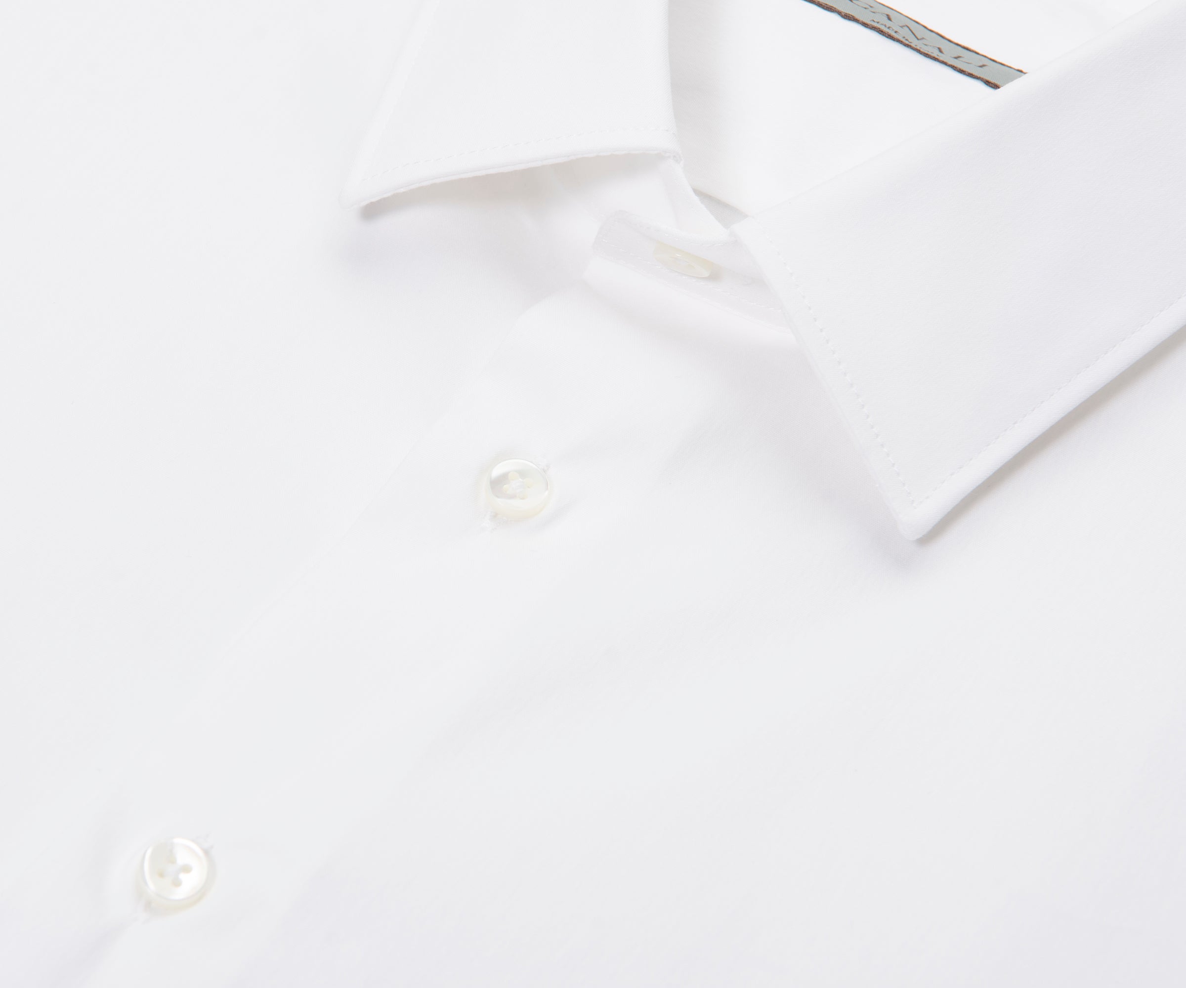 White dress shirt on a hanger against a white background