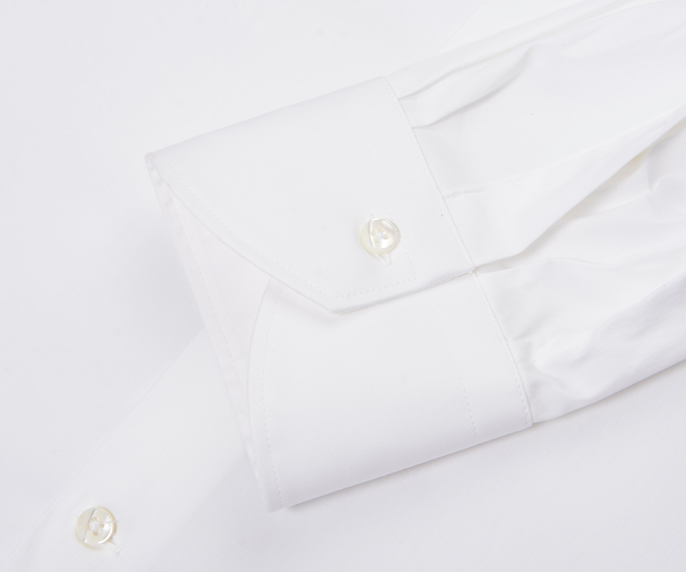 Close-up of a white shirt with buttons on a white background