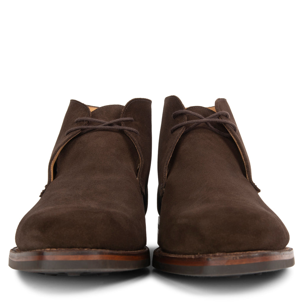 Pair of brown suede boots on a white background