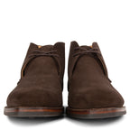 Pair of brown suede boots on a white background