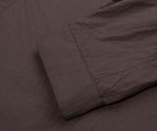 Dark brown textured fabric with a folded corner