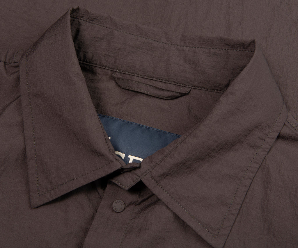 Close-up of Herno chocolate crinkle lightweight overshirt collar detail showing fabric texture and button fastening