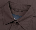 Close-up of Herno chocolate crinkle lightweight overshirt collar detail showing fabric texture and button fastening