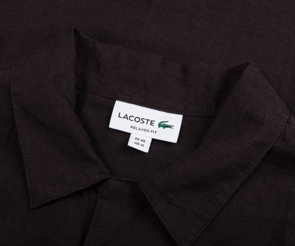 Black shirt with Lacoste label on a black background