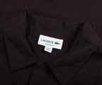 Black shirt with Lacoste label on a black background