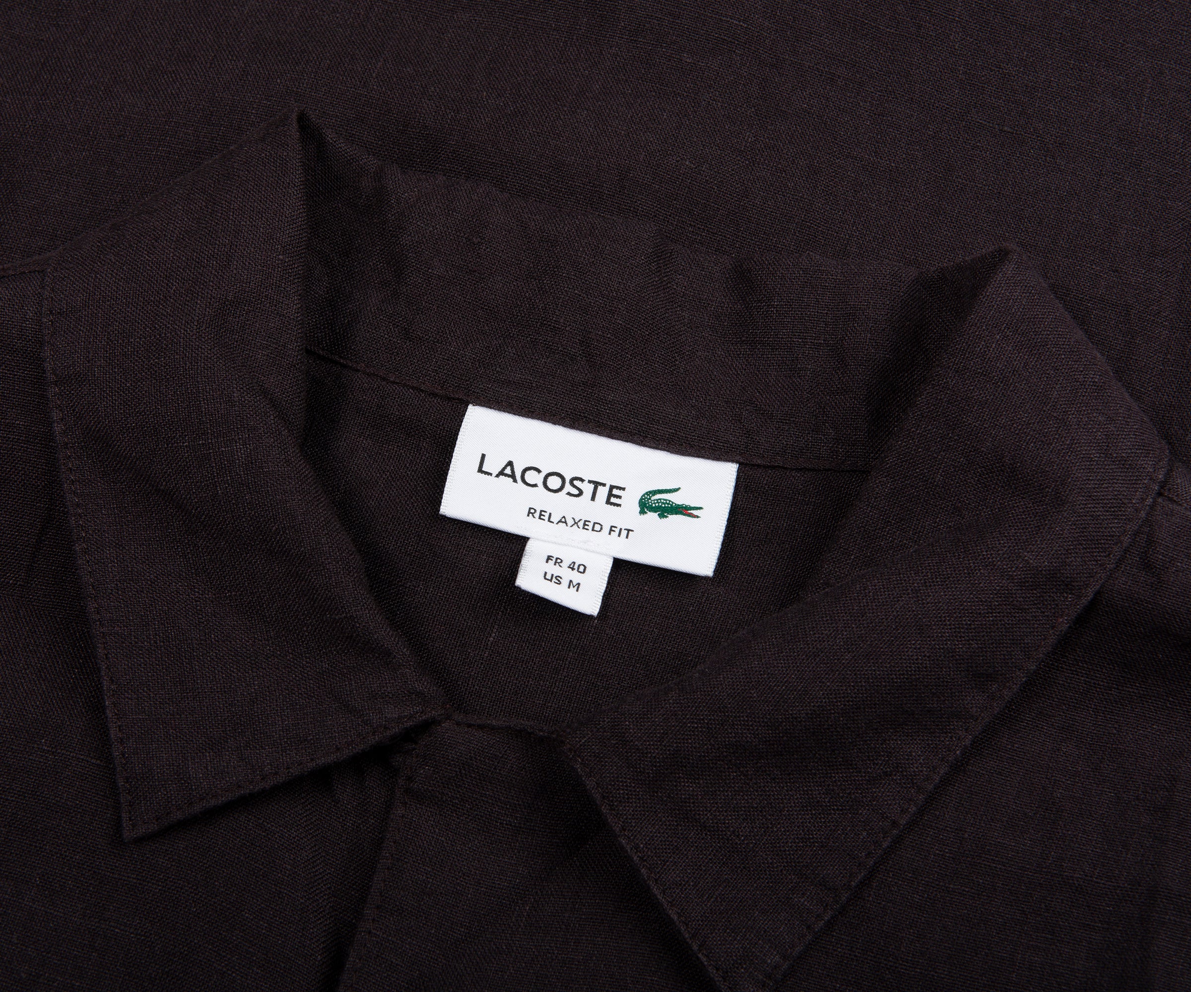 Black shirt with Lacoste label on a black background