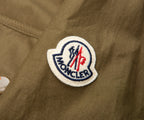 Moncler logo patch on a brown jacket