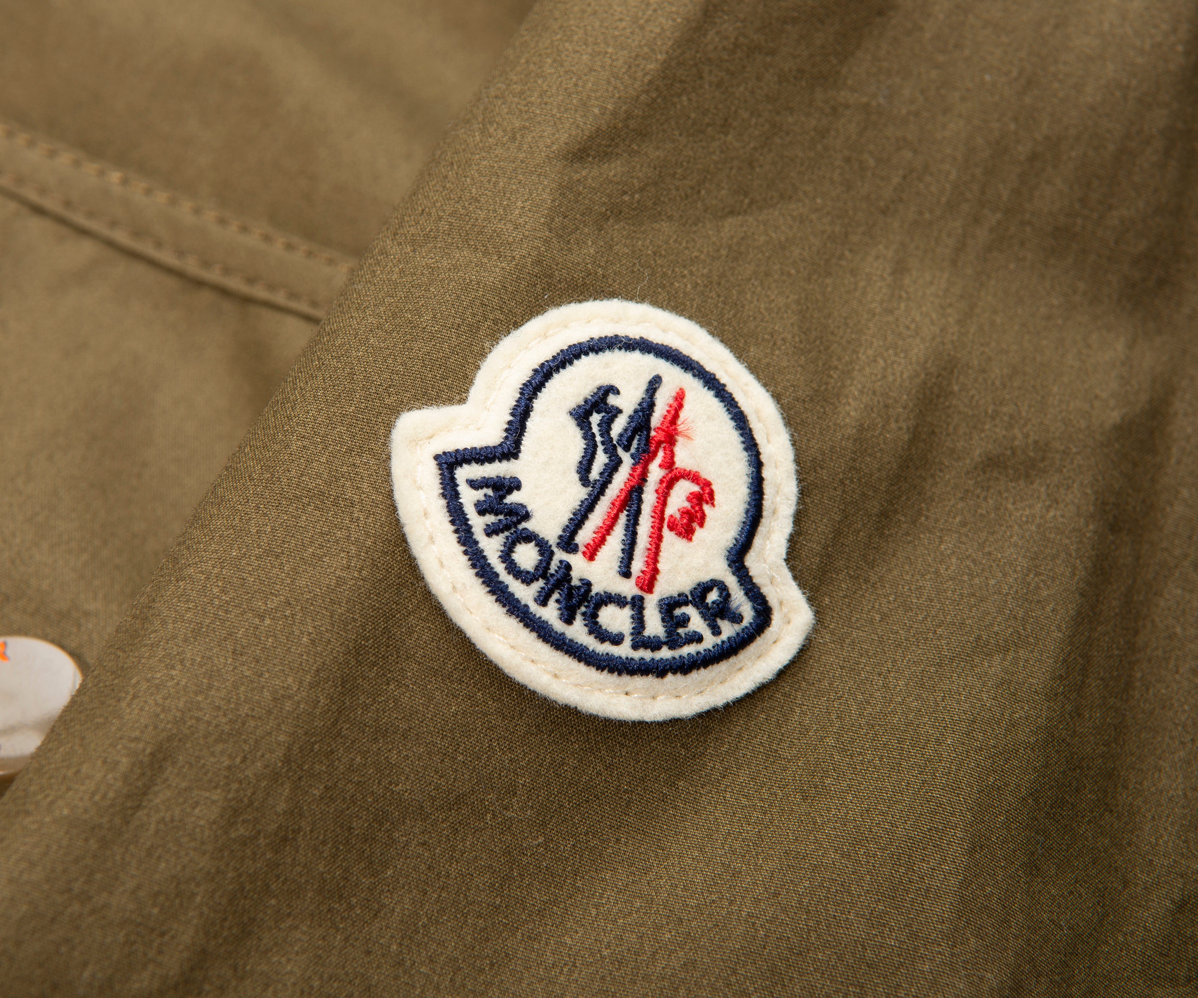 Moncler logo patch on a brown jacket