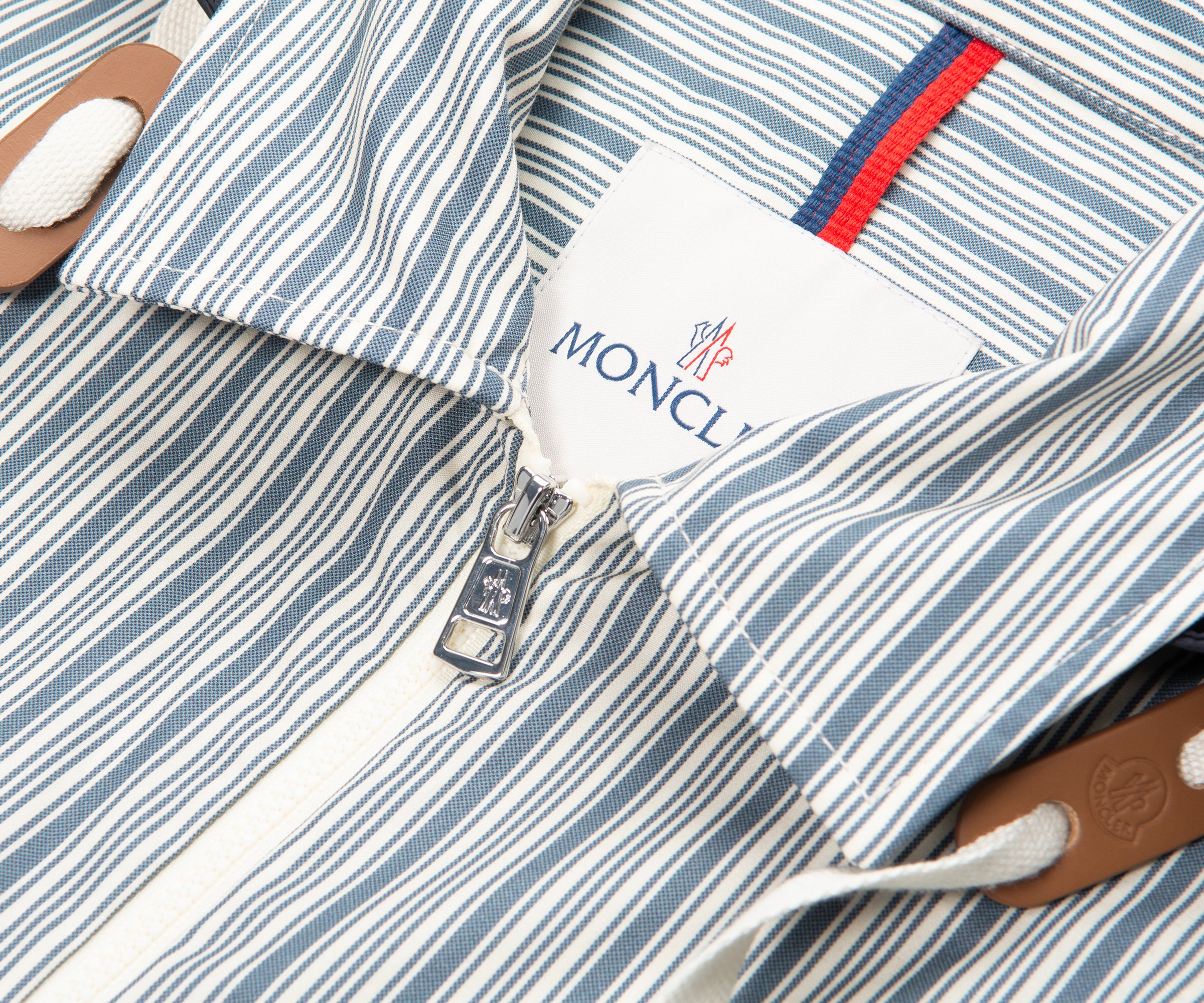 Close-up of a striped garment with a visible Moncler logo.