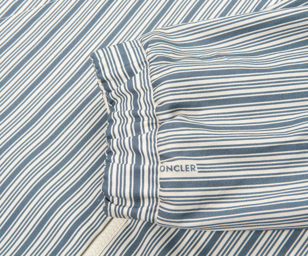 Close-up of a striped fabric with a visible brand logo, likely oncler.