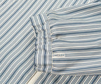 Close-up of a striped fabric with a visible brand logo, likely oncler.