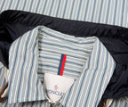 Striped jacket with a Moncler label on a striped background