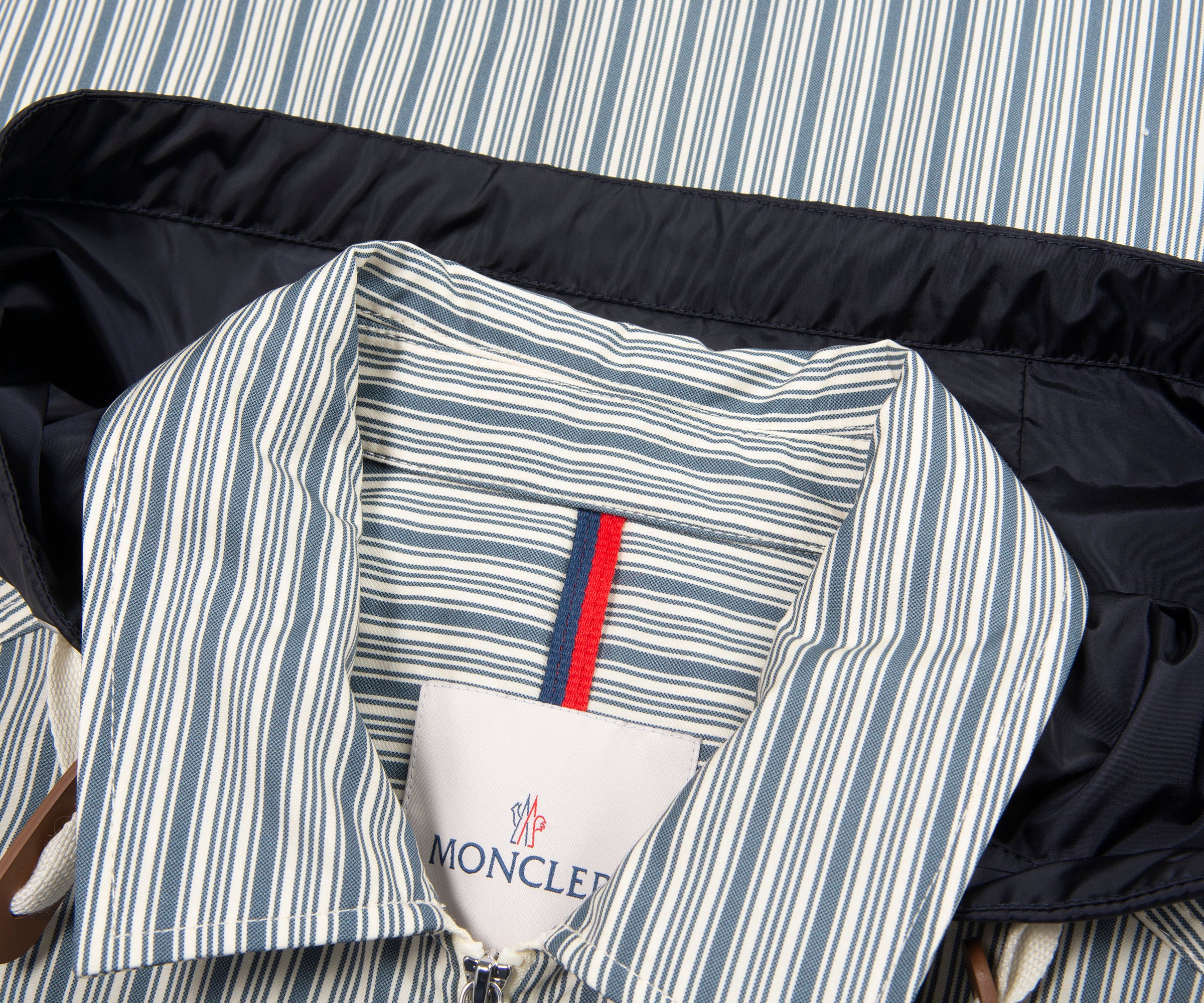 Striped jacket with a Moncler label on a striped background