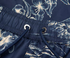 Navy blue swim shorts with white floral pattern and drawstring