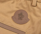 Close-up of a Moncler logo on a brown fabric background