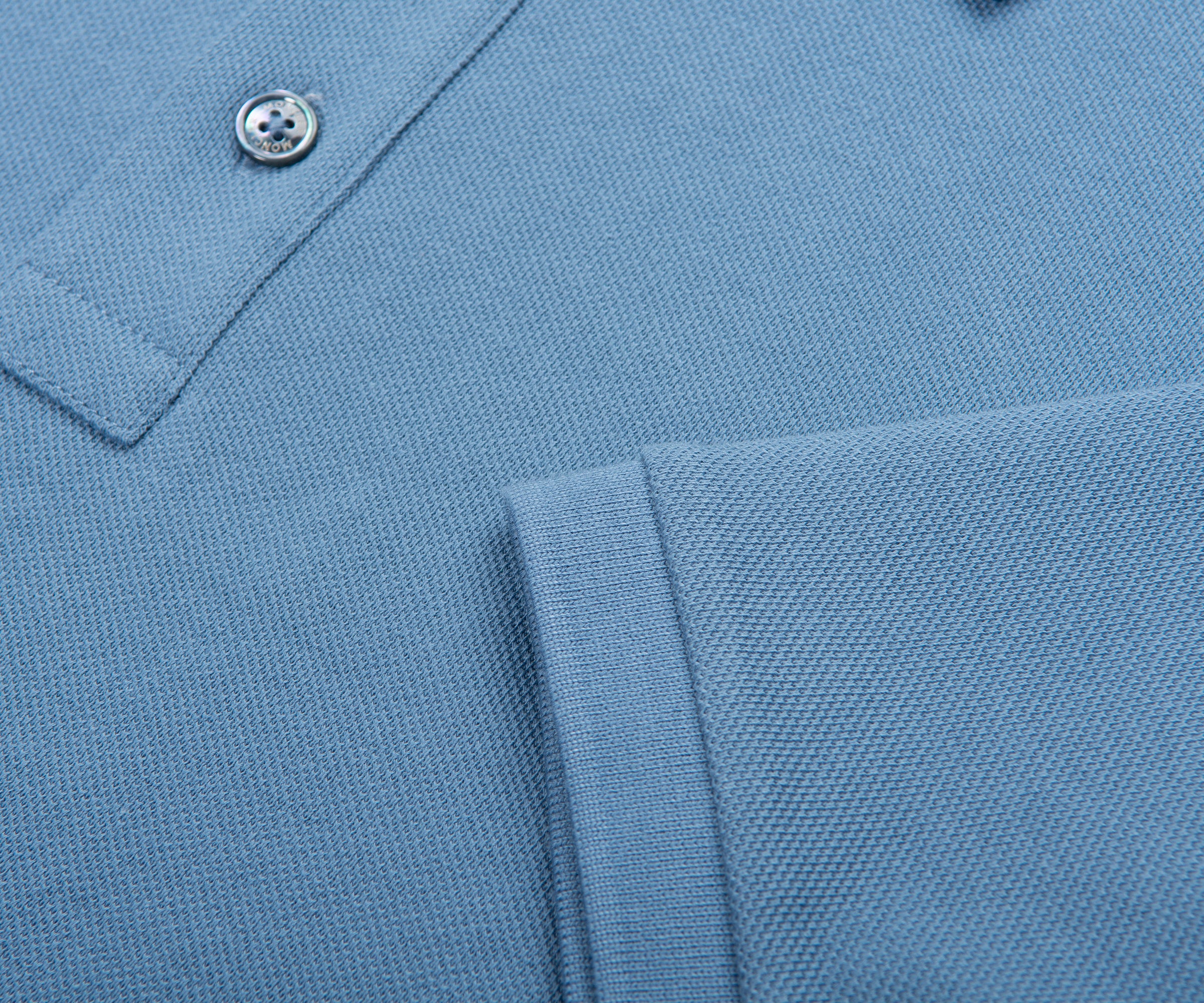 Close-up of a light blue polo shirt with a button