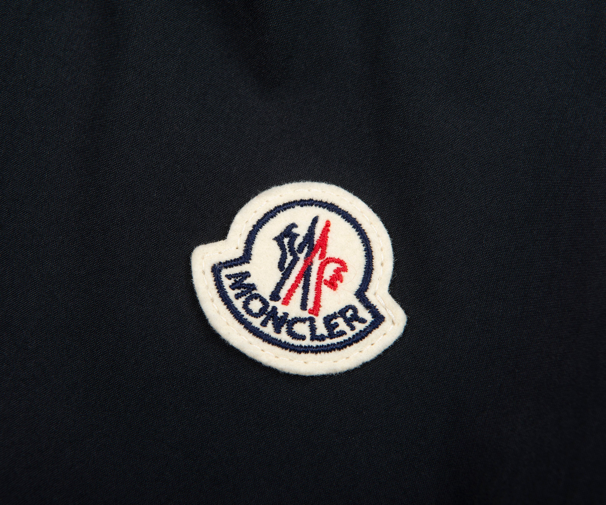 Moncler logo on a black background