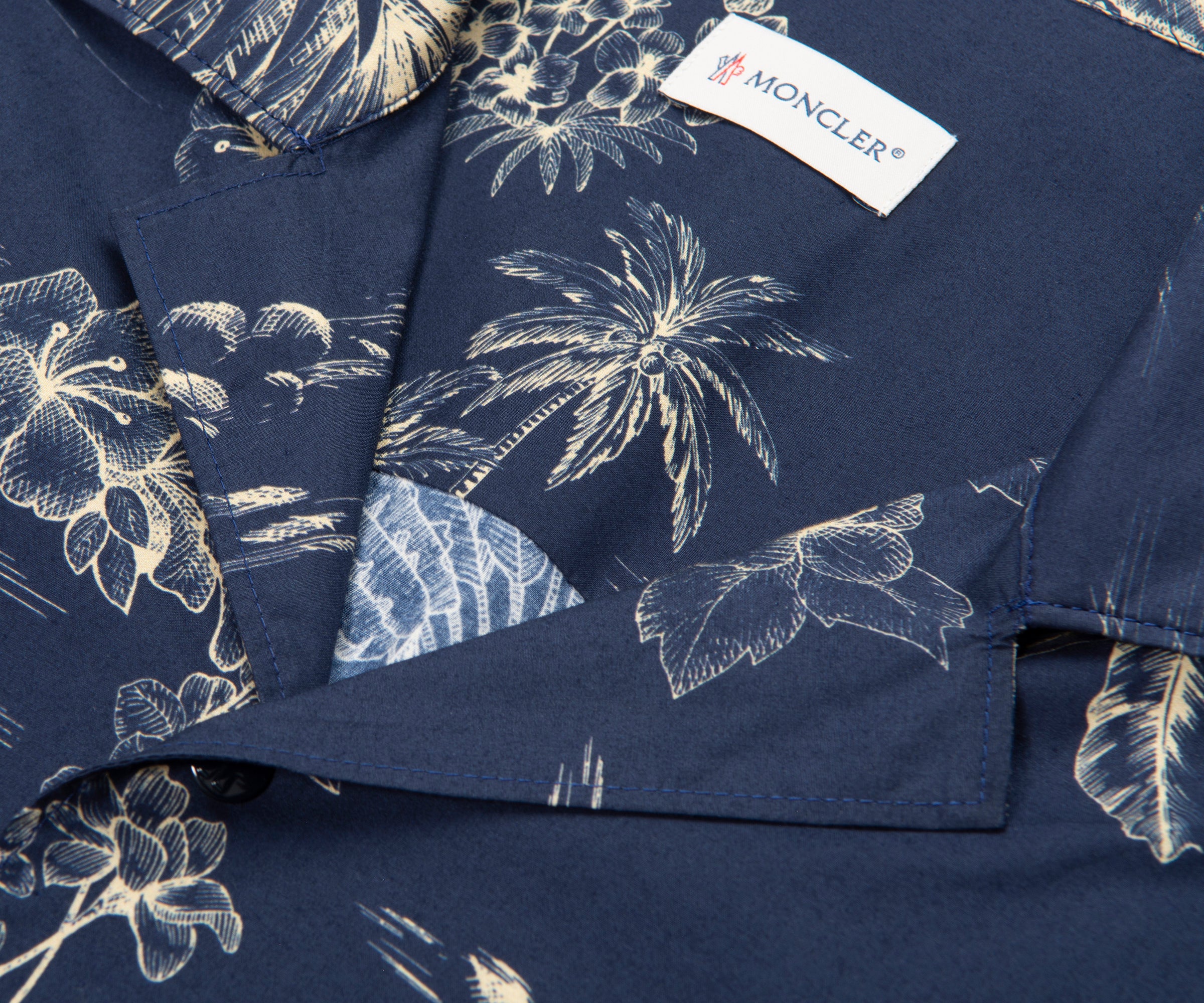 Navy blue shirt with white floral pattern and Moncler label