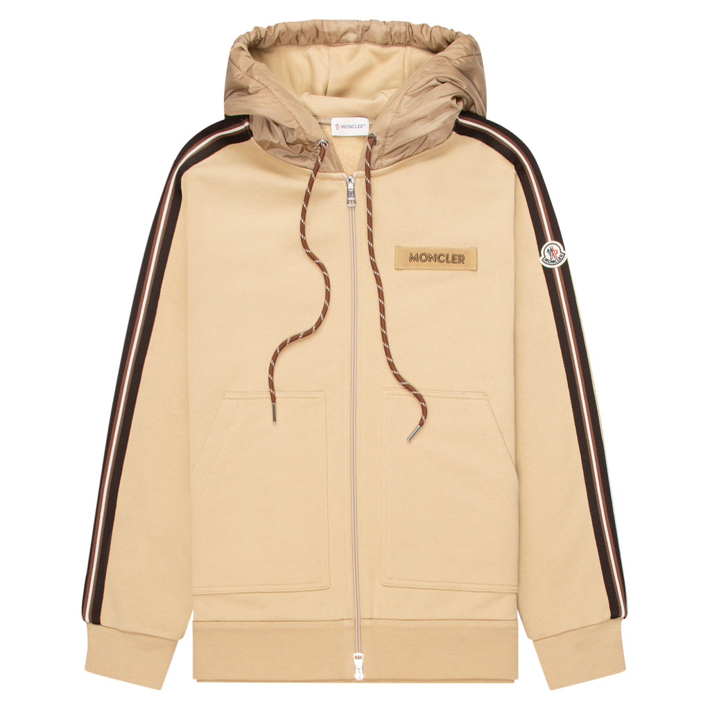 Beige hoodie with black stripes on sleeves and Moncler logo on chest, on a white background