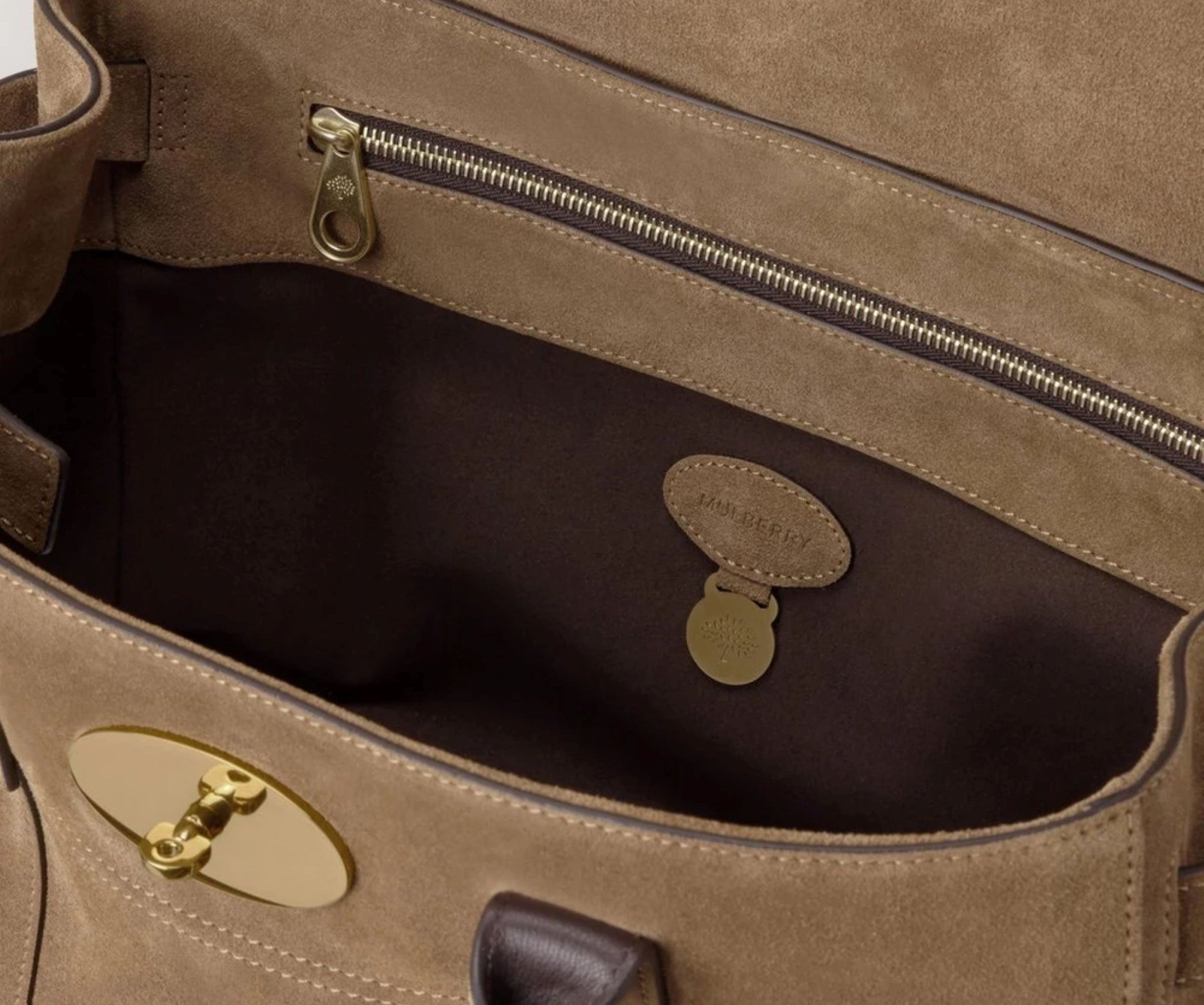 Close-up of a brown leather bag with gold hardware