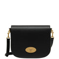 Black leather handbag with gold accents on a light gray background
