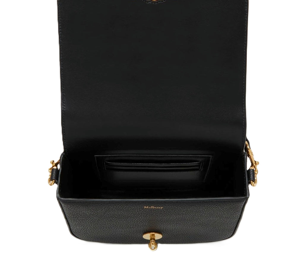 Black handbag with gold accents on a white background