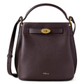 Brown leather handbag with gold accents on a white background