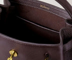 Close-up of a Mulberry leather handbag with gold hardware.