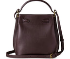 Brown leather handbag with a strap on a white background