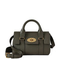 Green handbag with gold accents on a light gray background