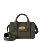 Green handbag with gold accents on a light gray background