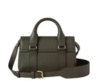 Green leather satchel bag with gold buckles on a light gray background