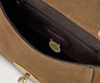 Brown Mulberry handbag with gold clasp on a light gray background