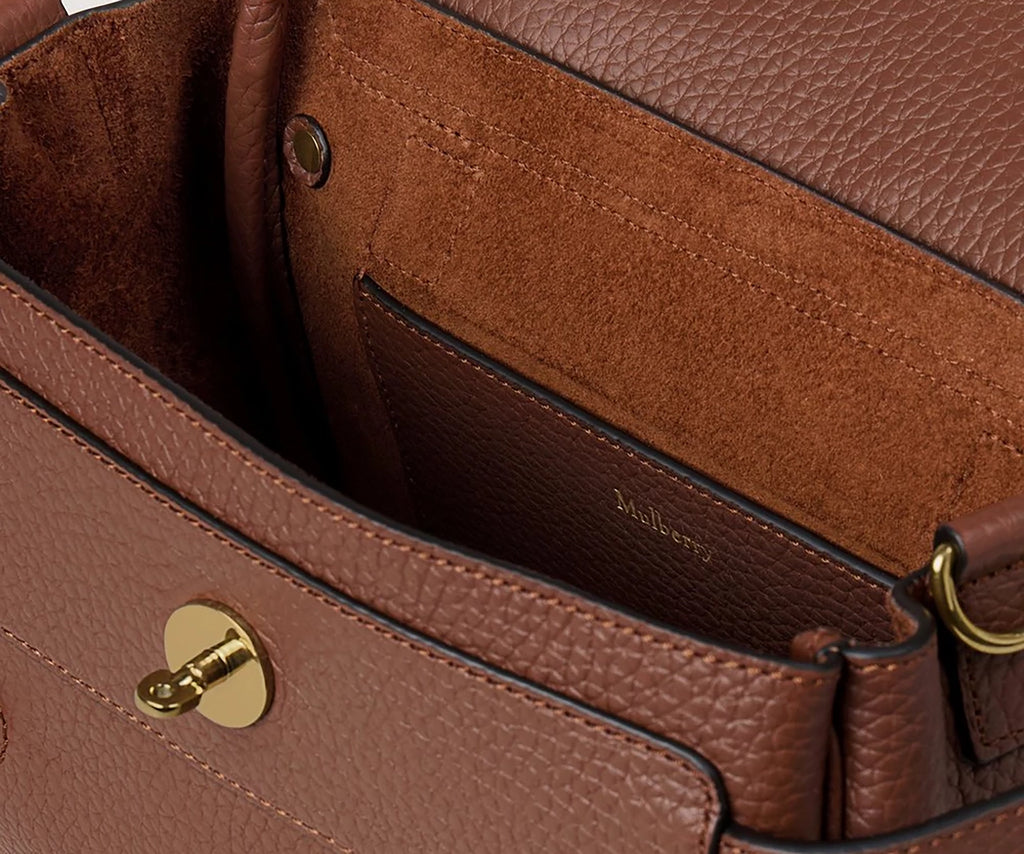 Close-up of a brown leather handbag with gold hardware, featuring the Mulberry brand.