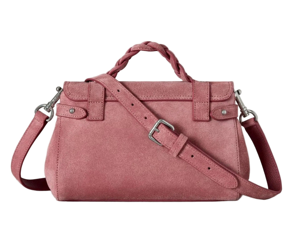 Pink handbag with a strap on a light gray background