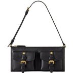 Black leather handbag with gold buckles on a light gray background