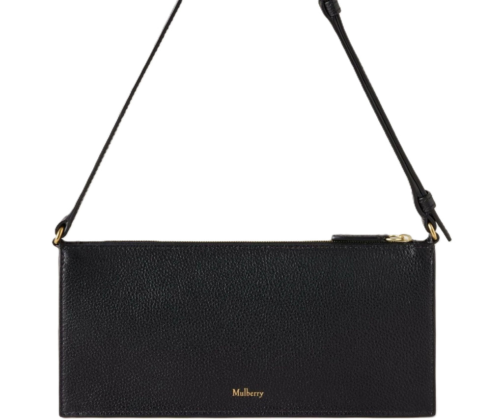 Black handbag with a strap on a white background